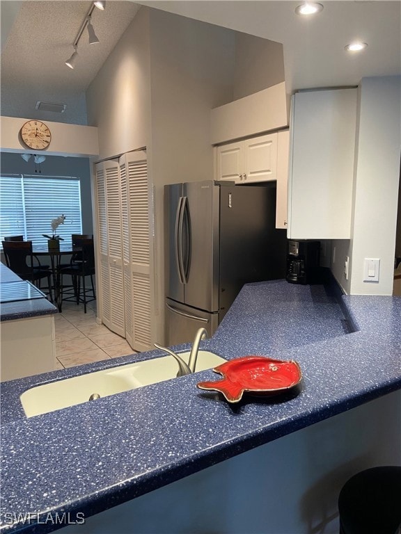Kitchen featuring freestanding refrigerator, light