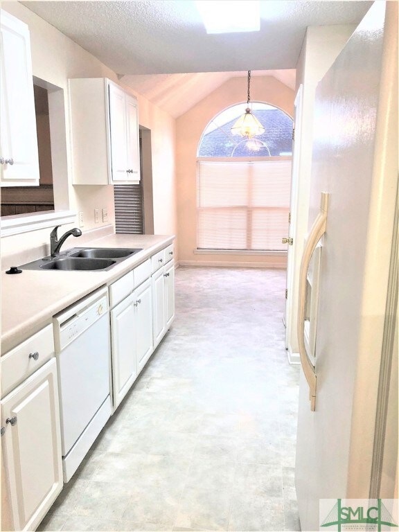 Galley kitchen that opens up into the breakfast ar