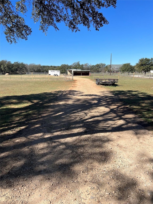 View of street with a rural view and driveway