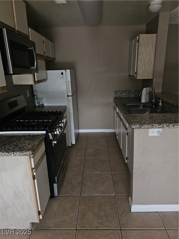 Kitchen with a sink, dark tile patterned floors, r