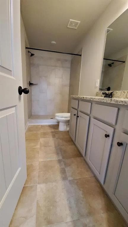 Full bath featuring vanity, a stall shower, and light tile patterned floors