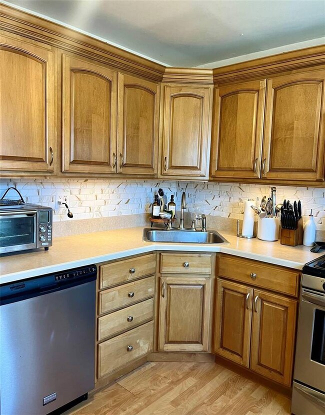 Kitchen featuring light countertops, appliances wi