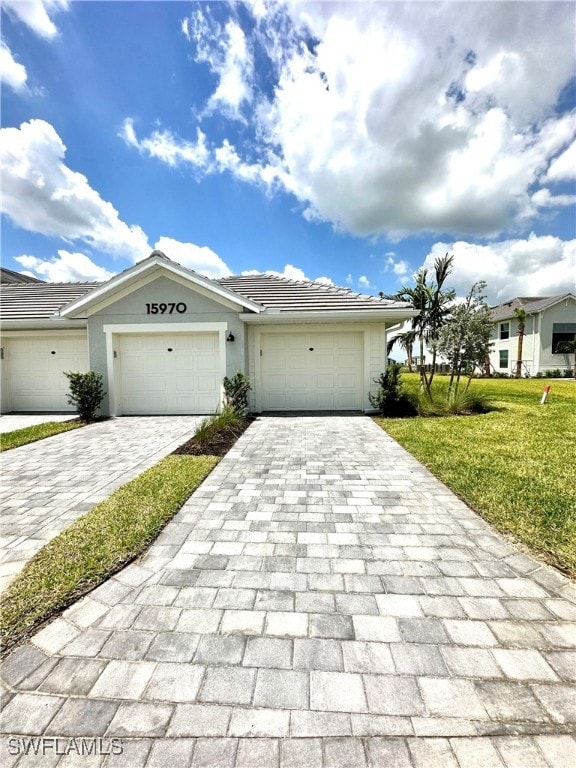Single story home featuring a garage and a front y