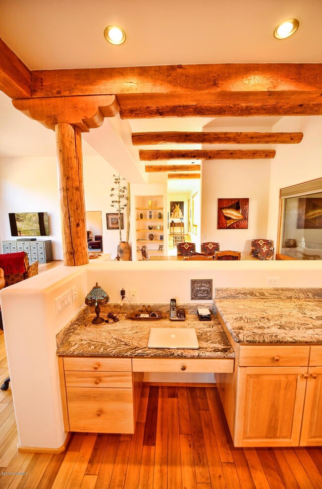 Kit. Desk view of hall to all BR