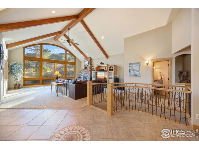 Entry Way with custom curved staircase and beamed ceilings