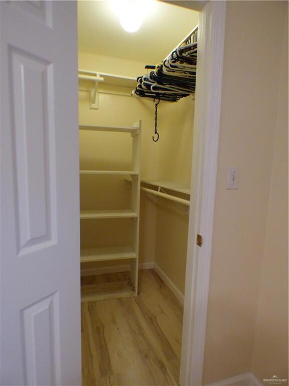 Walk in closet featuring light wood finished floors