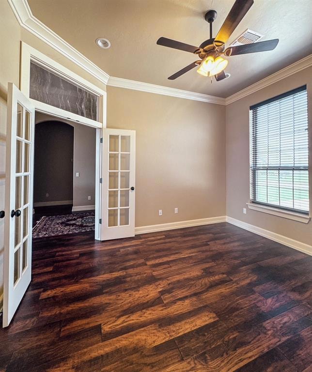 Unfurnished room featuring french doors, ornamental molding, wood finished floors, and ceiling fan