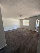 Unfurnished room with a textured ceiling