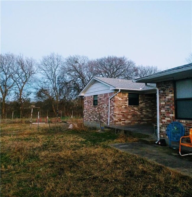 Backside of home views the creek and four acres of