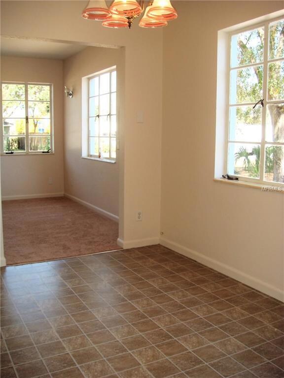 This photo is of the dining area leading into the living room.  There are plenty of windows making it very bright.