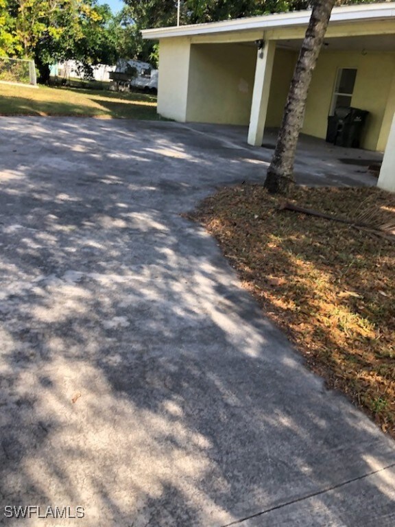 View of property exterior with a carport