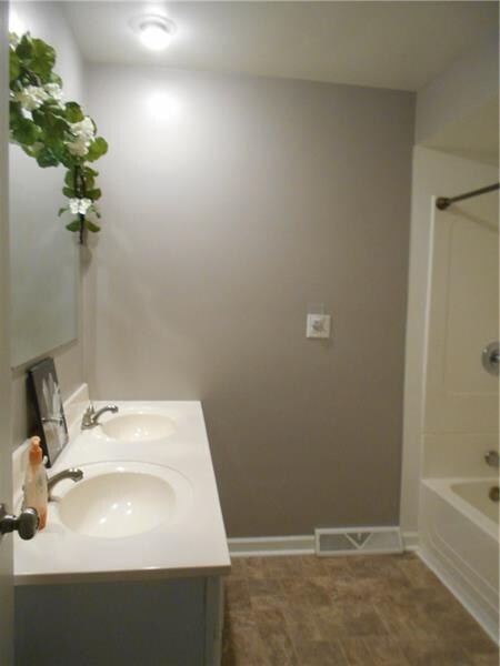 Full bath with double sink vanity.