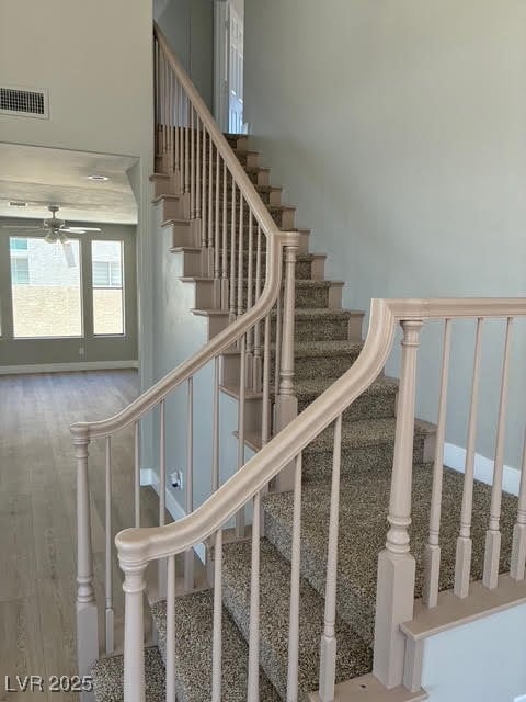 Stairway featuring a ceiling fan