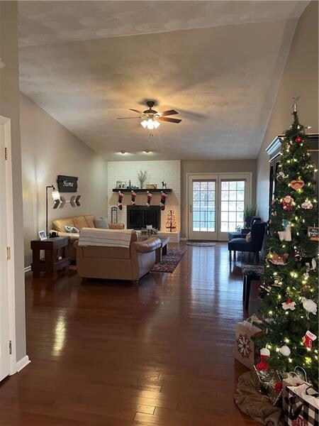 View from Foyer - note high cathedral ceiling hardwood flooring wood fireplace.