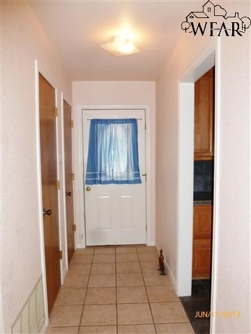 Tiled entryway with window and hall closet.