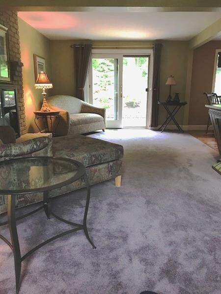 Main level family room with gas fireplace and slid