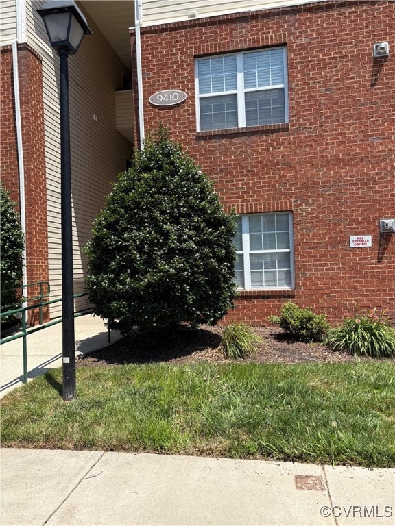 View of side of property with brick siding