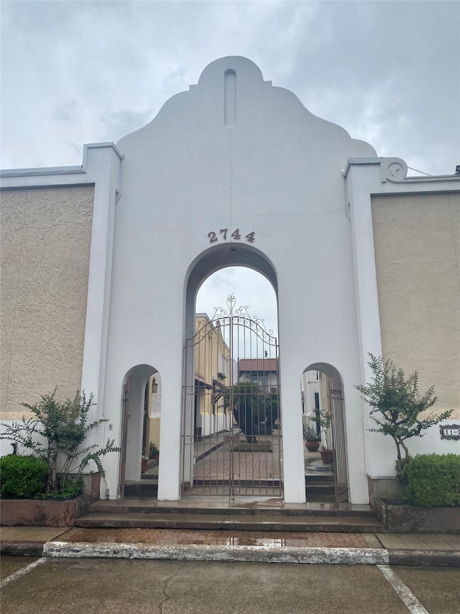 Spanish Style Stucco building with an arch entry w