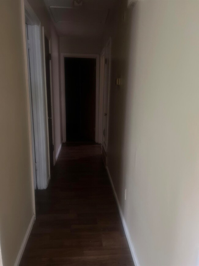 Hall with hardwood / wood-style flooring