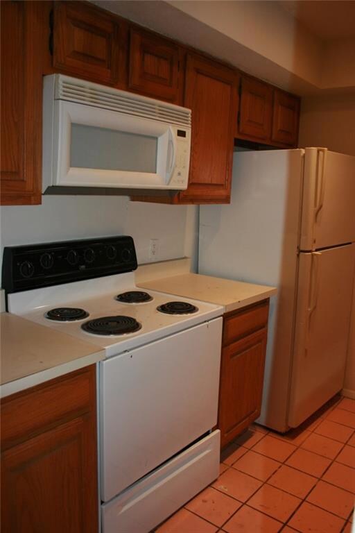 Kitchen includes refrigerator and built-in microwa