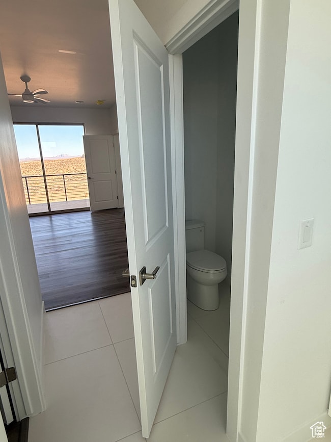 Bathroom featuring light tile patterned floors and a ceiling fan