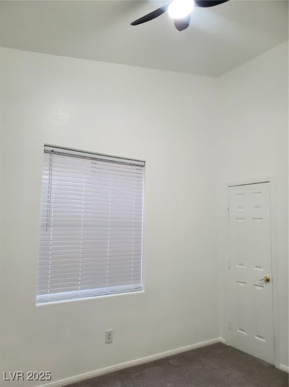 Spare room featuring ceiling fan, dark colored car