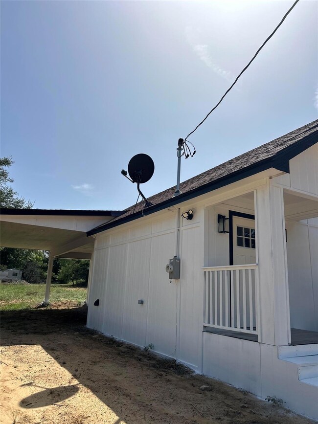 View of side of property with a carport