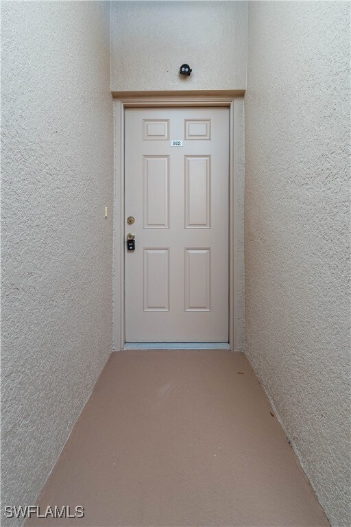 Property entrance with stucco siding