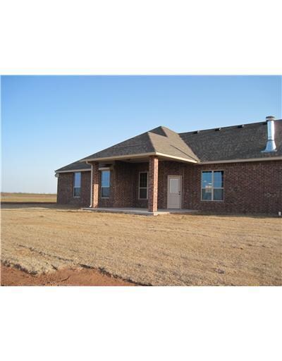 Exterior Back. Big .75 acre yard and large covered
