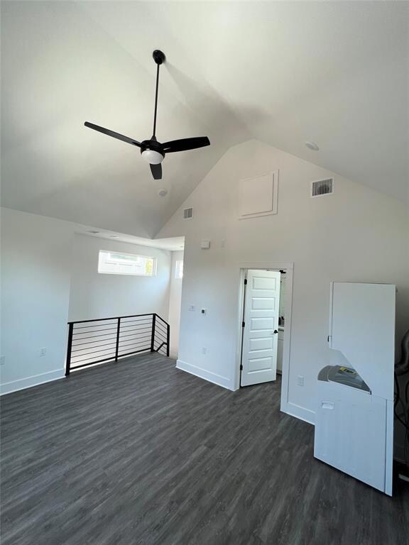 Spare room featuring a ceiling fan, high vaulted 