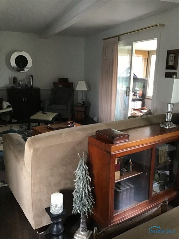 LR opens up to enclosed porch with a tree top view
