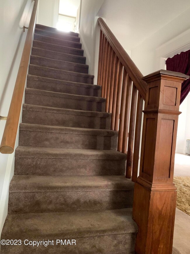 2023 405 E Center foyer stairway IMG_139