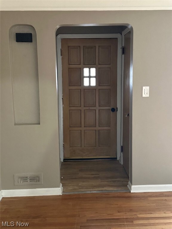 Entryway featuring dark wood-type flooring