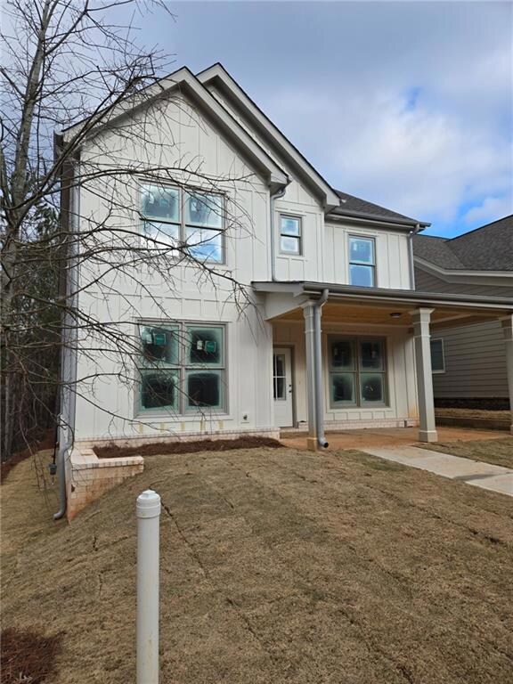 View of front of house with board and batten sidin