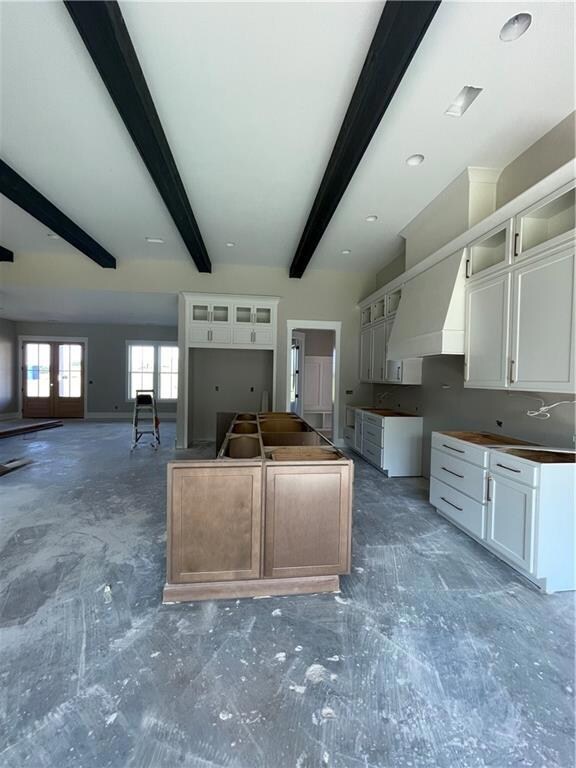 Kitchen featuring beam ceiling, glass insert cabin