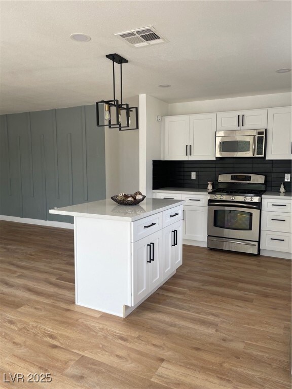 Kitchen featuring visible vents, light wood-style