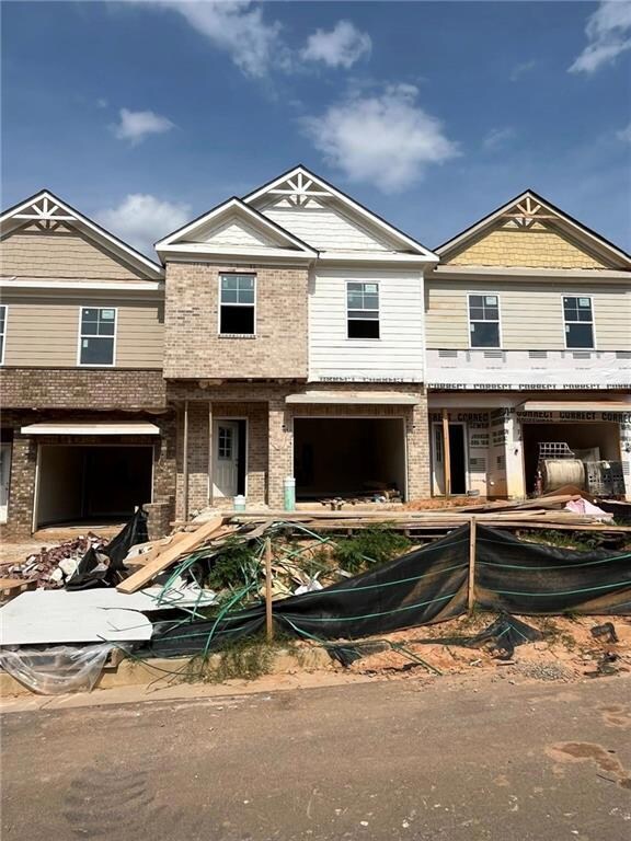 Multi unit property with brick siding and a garage