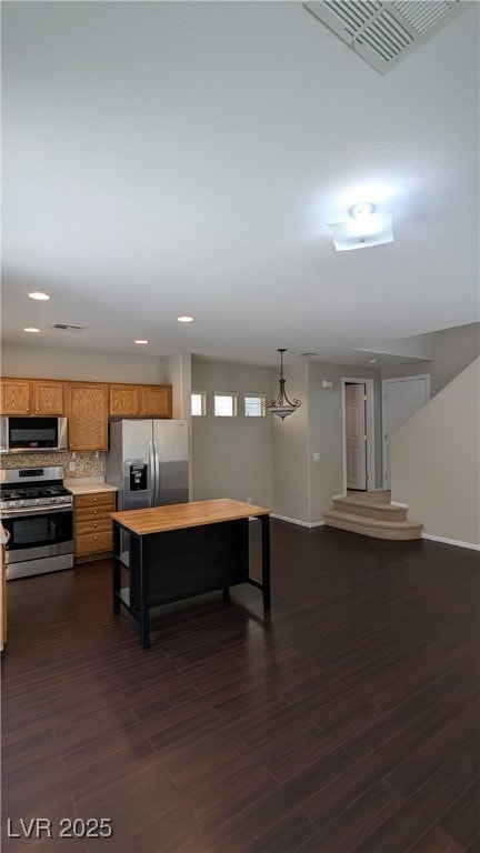 Kitchen with stainless steel appliances, brown cab