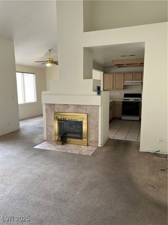 Unfurnished living room featuring ceiling fan, lig