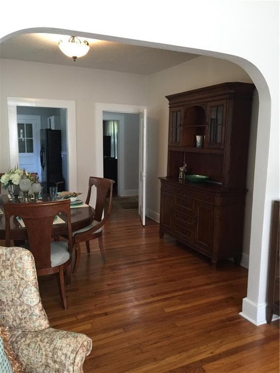 Dining area with baseboards, wood finished floors,