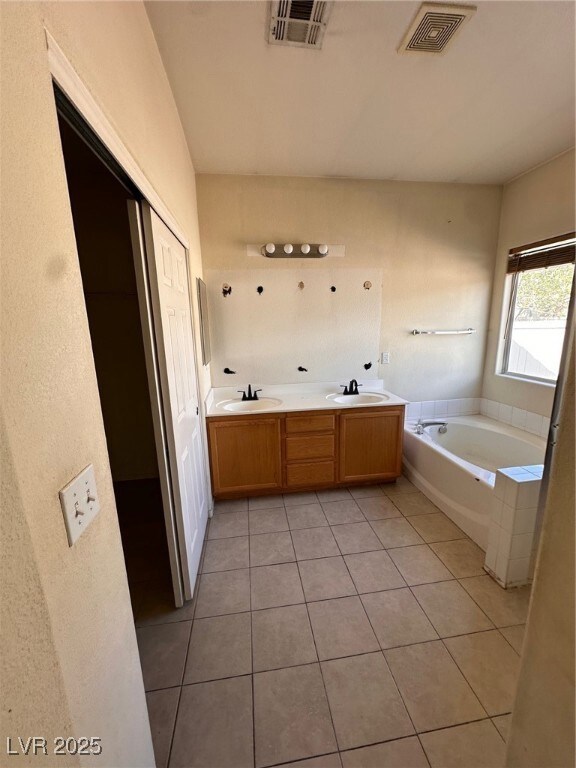 Bathroom with a sink, visible vents, and a garden