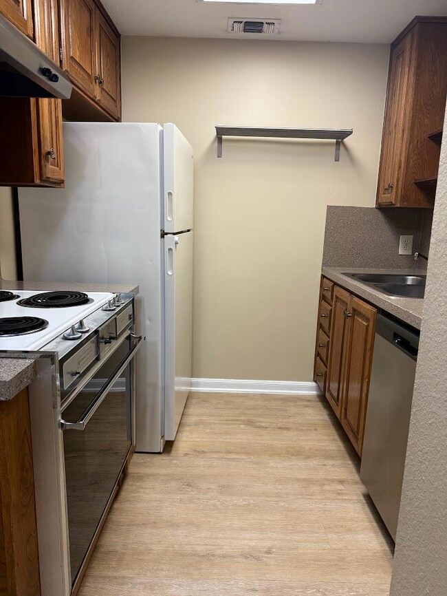 Kitchen with dishwasher, under cabinet range hood