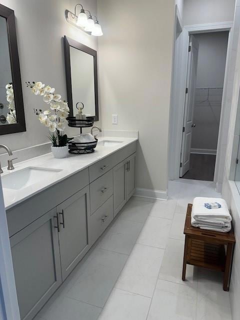 Bathroom with double vanity and a spacious closet.  AMAZING walk -in shower with dual shower heads.  Tile upgrades to ceiling!