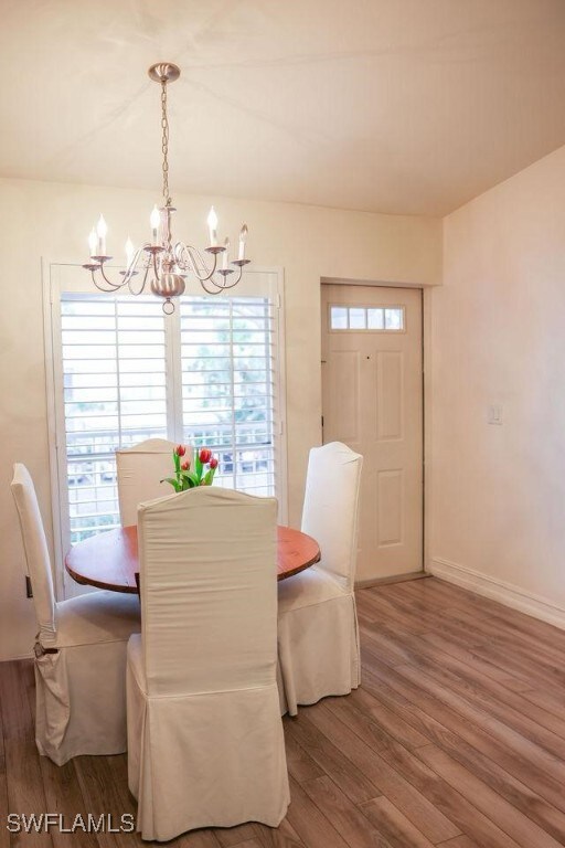Dining area with an inviting chandelier, baseboard