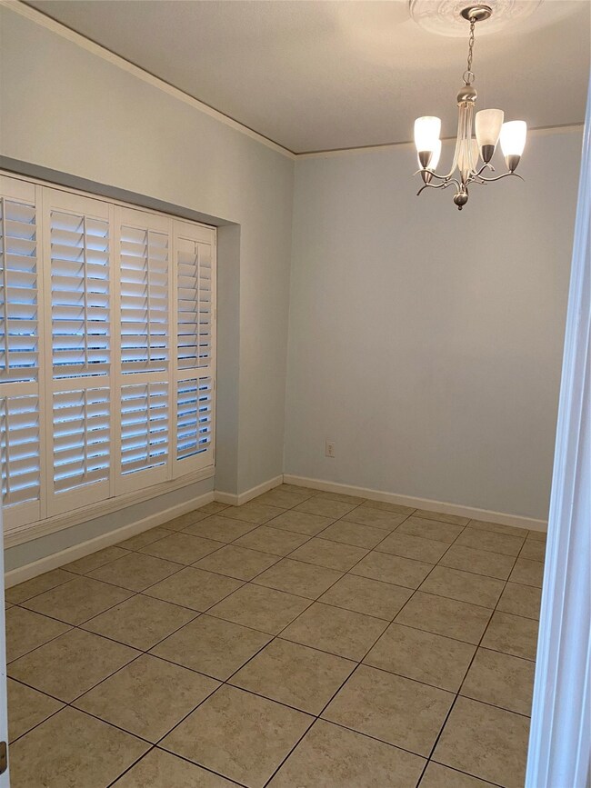 Beautiful plantation shutters and tile in 4th bedroom downstairs. Also serves as the perfect home office area.