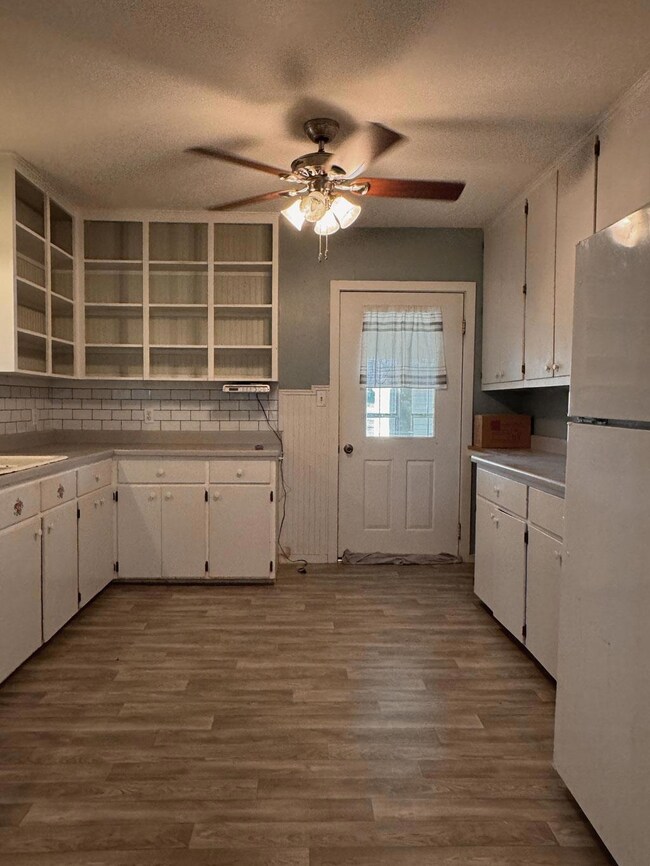 Kitchen with freestanding refrigerator, open shel