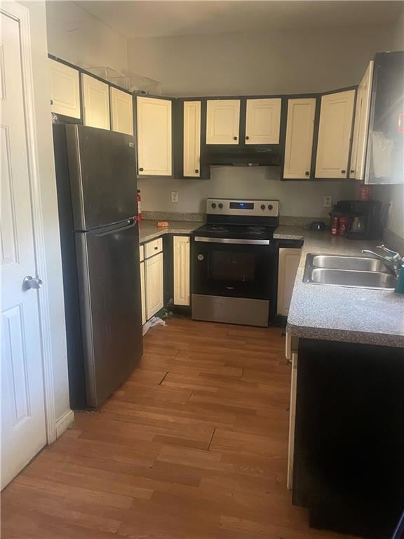 Kitchen with white cabinets, wood-type flooring, s