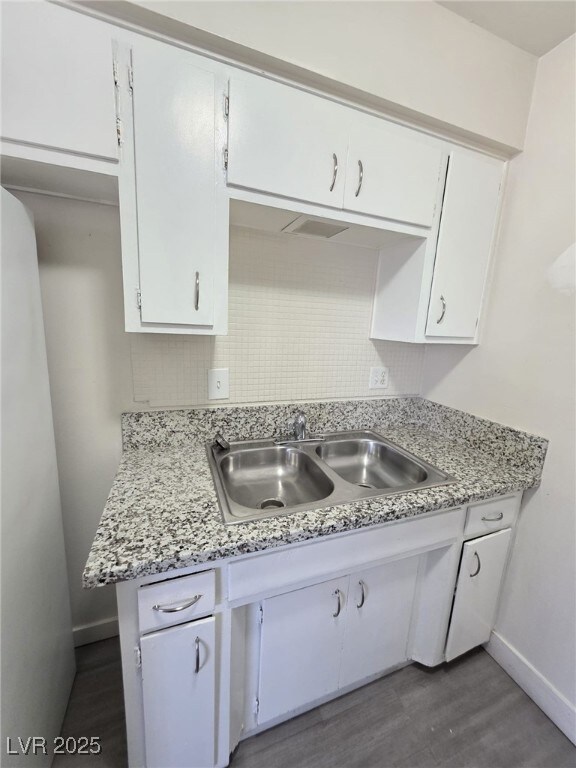 Kitchen with white cabinets, light countertops, da