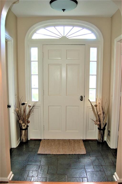 Foyer with slate flooring. Closet and powder room 