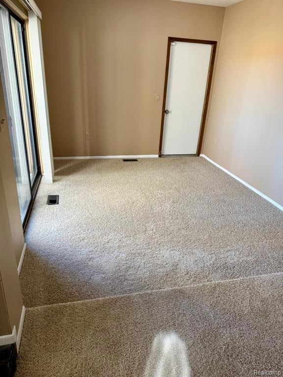 Spare room featuring carpet